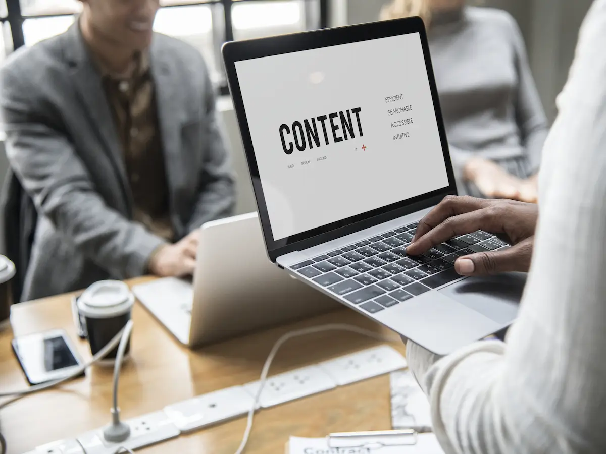 A copywriter having a laptopn in his hands typing